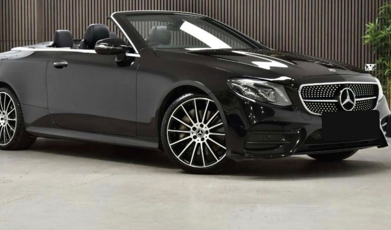 Black Mercedes-Benz E-Class convertible shown from the front with the roof down